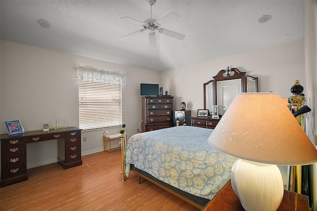 1007 Diego Ct, The Villages, FL 32159 - bedroom with wood finished floors, a textured ceiling, and ceiling fan