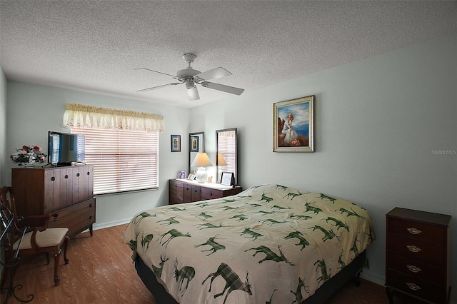 1007 Diego Ct, The Villages, FL 32159 - bedroom with wood finished floors, a textured ceiling, and ceiling fan