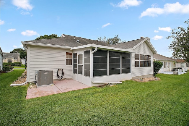 1007 Diego Ct, The Villages, FL 32159 - back of house with a sunroom, a patio, a yard, and a shingled roof
