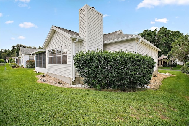 1007 Diego Ct, The Villages, FL 32159 - view of side of property featuring a chimney, a yard, and a sunroom