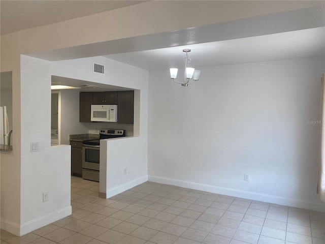 624 Australian Way, Davenport, FL 33897 - unfurnished dining area with light tile patterned floors and a chandelier