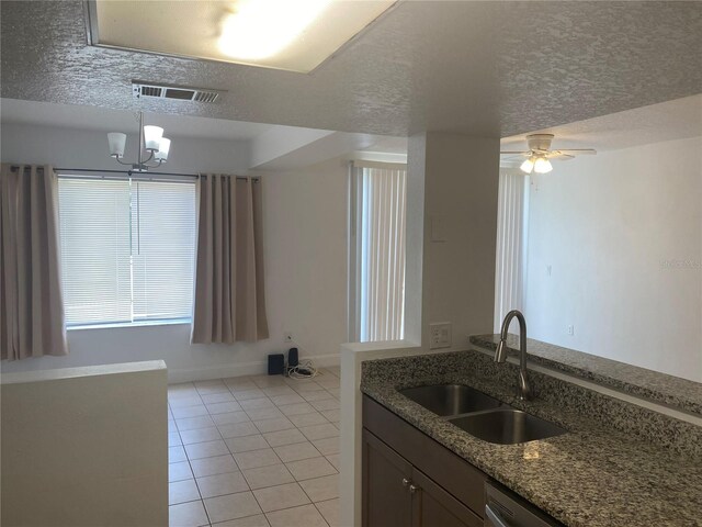 624 Australian Way, Davenport, FL 33897 - kitchen with light tile patterned flooring, a textured ceiling, light stone countertops, a chandelier, and a ceiling fan