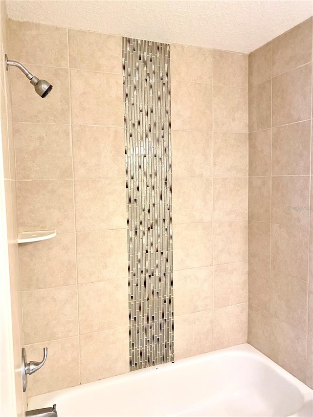 624 Australian Way, Davenport, FL 33897 - full bathroom with  shower combination and a textured ceiling