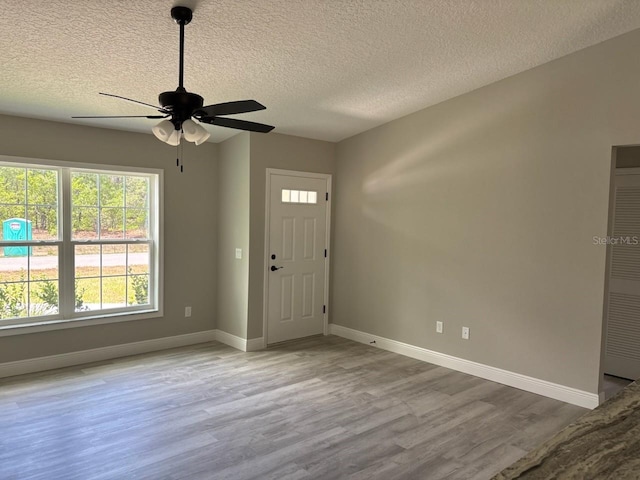 6769 N Waterman Dr, Dunnellon, FL 34433 - foyer entrance featuring wood finished floors, a textured ceiling, and a ceiling fan