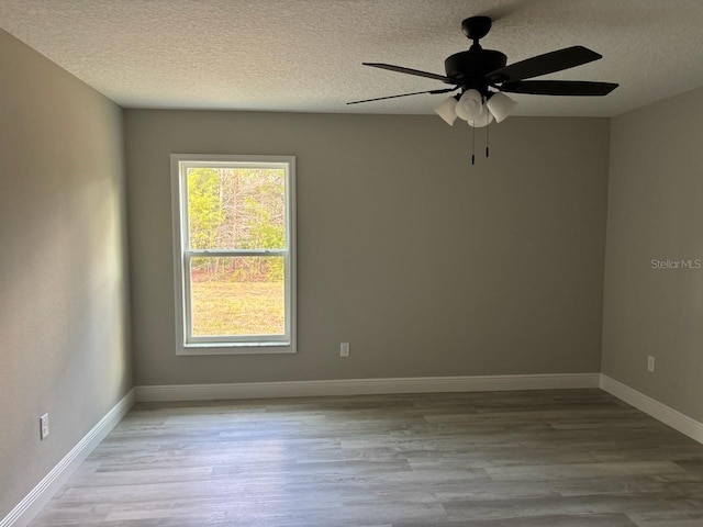 6769 N Waterman Dr, Dunnellon, FL 34433 - empty room with a textured ceiling, wood finished floors, and ceiling fan
