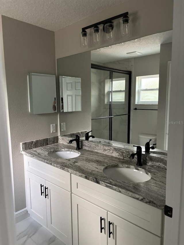 6769 N Waterman Dr, Dunnellon, FL 34433 - full bath with a textured ceiling, double vanity, a shower stall, and marble look tiles