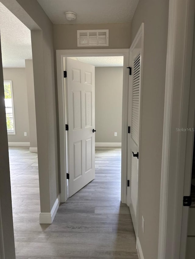 6769 N Waterman Dr, Dunnellon, FL 34433 - corridor featuring wood finished floors and baseboards