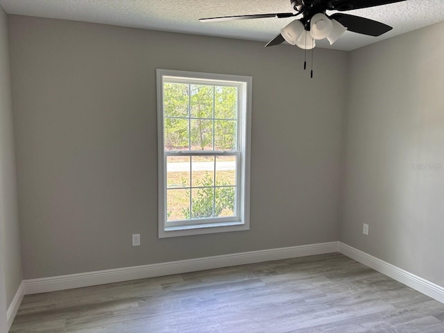6769 N Waterman Dr, Dunnellon, FL 34433 - empty room with wood finished floors, a ceiling fan, and a textured ceiling