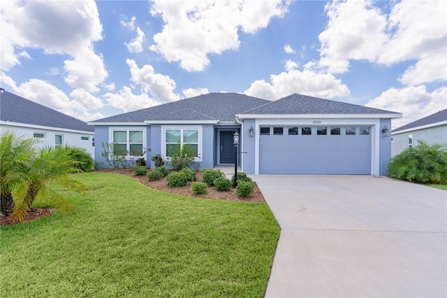 6949 Minchew Cir, The Villages, FL 34762 - ranch-style house with stucco siding, an attached garage, driveway, a front lawn, and roof with shingles