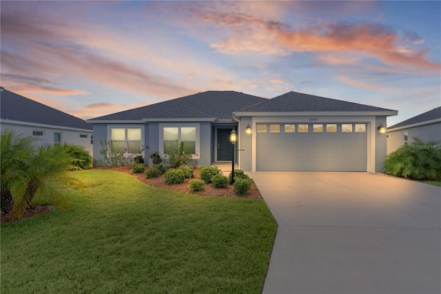 6949 Minchew Cir, The Villages, FL 34762 - view of front of home with stucco siding, a garage, driveway, a yard, and roof with shingles