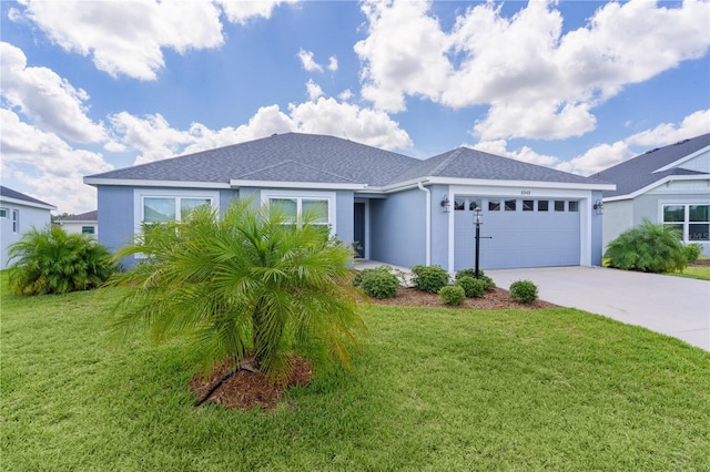 6949 Minchew Cir, The Villages, FL 34762 - ranch-style house with a garage, driveway, a front yard, stucco siding, and a shingled roof