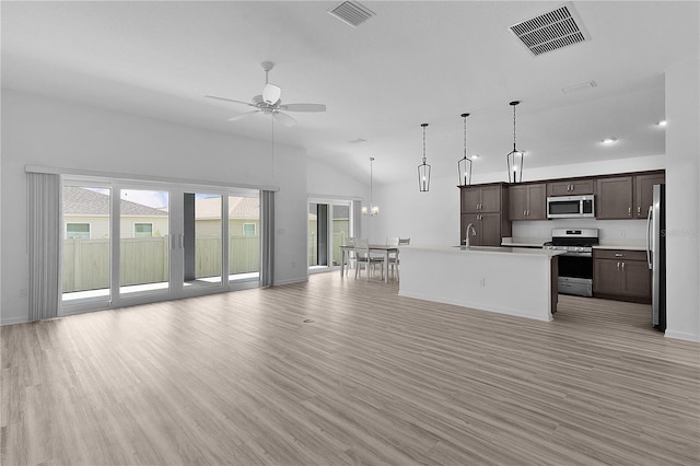 6949 Minchew Cir, The Villages, FL 34762 - unfurnished living room with ceiling fan, light wood-type flooring, a chandelier, and lofted ceiling