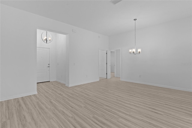 6949 Minchew Cir, The Villages, FL 34762 - spare room featuring a chandelier and light wood finished floors