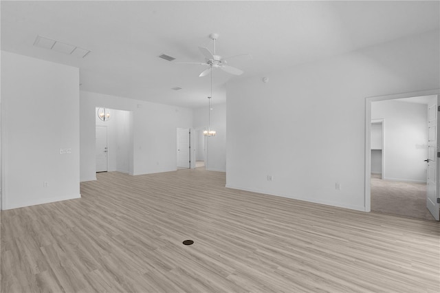 6949 Minchew Cir, The Villages, FL 34762 - unfurnished living room with a chandelier, a ceiling fan, and light wood-type flooring
