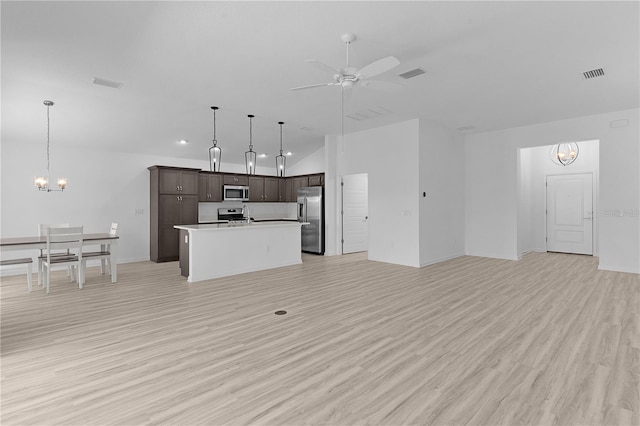 6949 Minchew Cir, The Villages, FL 34762 - kitchen with appliances with stainless steel finishes, a chandelier, open floor plan, dark brown cabinetry, and recessed lighting
