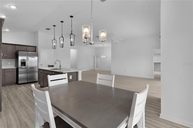 6949 Minchew Cir, The Villages, FL 34762 - dining area featuring light wood-style flooring, a chandelier, and ceiling fan