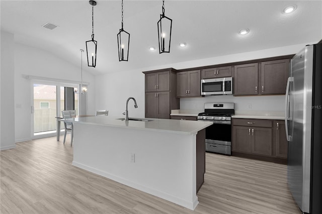6949 Minchew Cir, The Villages, FL 34762 - kitchen featuring stainless steel appliances, dark brown cabinetry, light countertops, light wood-type flooring, and lofted ceiling