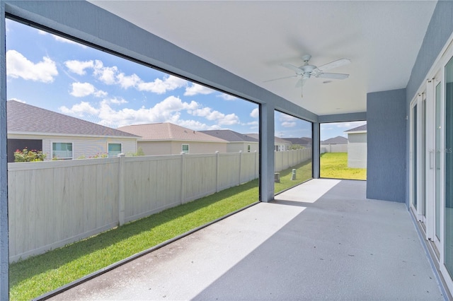6949 Minchew Cir, The Villages, FL 34762 - unfurnished sunroom featuring ceiling fan and a residential view