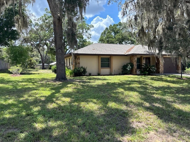 7186 N Whippoorwill Ter, Hernando, FL 34442 - view of front of property featuring an attached garage, stucco siding, and a front lawn