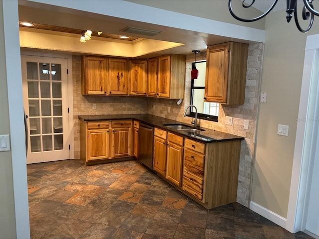 7186 N Whippoorwill Ter, Hernando, FL 34442 - kitchen featuring dishwasher, dark countertops, brown cabinetry, tasteful backsplash, and dark stone finish flooring