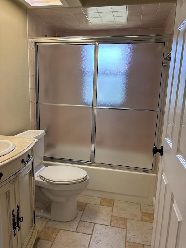 7186 N Whippoorwill Ter, Hernando, FL 34442 - full bathroom with vanity, enclosed tub / shower combo, and stone tile floors