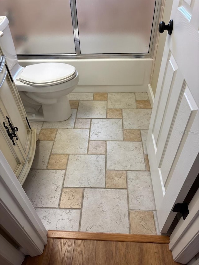 7186 N Whippoorwill Ter, Hernando, FL 34442 - bathroom with stone tile flooring and combined bath / shower with glass door