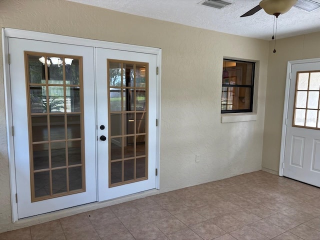 7186 N Whippoorwill Ter, Hernando, FL 34442 - doorway with french doors, a textured wall, ceiling fan, and a textured ceiling