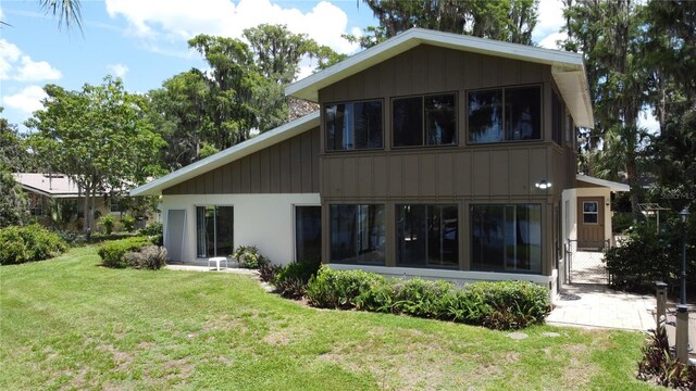 11401 Cypress Dr, Clermont, FL 34711 - rear view of house featuring a lawn