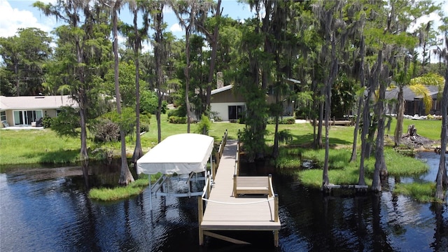 11401 Cypress Dr, Clermont, FL 34711 - dock with a water view, a lawn, boat lift, and view of wooded area