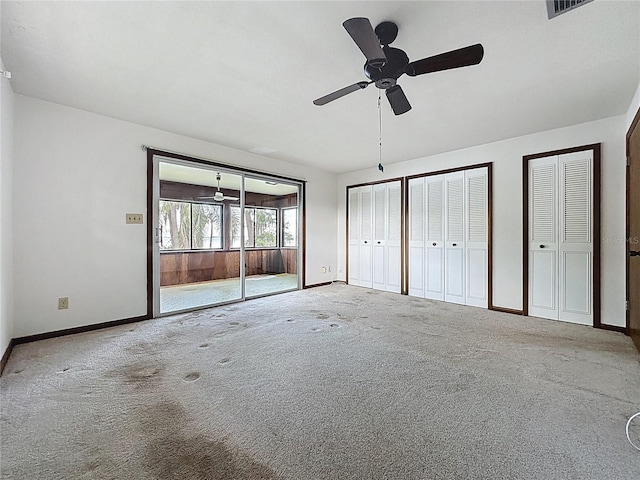 11401 Cypress Dr, Clermont, FL 34711 - unfurnished bedroom featuring two closets, carpet floors, and a ceiling fan