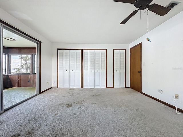 11401 Cypress Dr, Clermont, FL 34711 - unfurnished bedroom featuring two closets, carpet flooring, and a ceiling fan