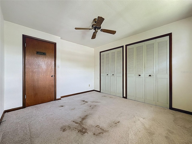 11401 Cypress Dr, Clermont, FL 34711 - unfurnished bedroom featuring multiple closets, carpet flooring, and ceiling fan