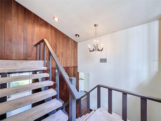 11401 Cypress Dr, Clermont, FL 34711 - staircase with wooden walls, a chandelier, and lofted ceiling