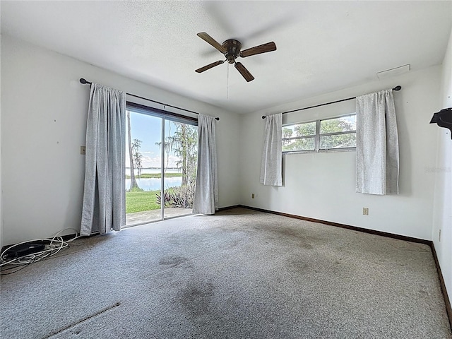 11401 Cypress Dr, Clermont, FL 34711 - carpeted spare room with a ceiling fan and a water view