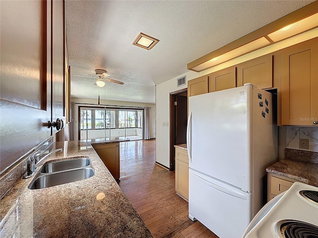 11401 Cypress Dr, Clermont, FL 34711 - kitchen featuring white appliances, a textured ceiling, light wood finished floors, a ceiling fan, and light stone countertops