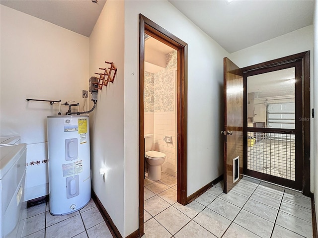 11401 Cypress Dr, Clermont, FL 34711 - laundry area featuring water heater, washing machine and clothes dryer, and light tile patterned floors