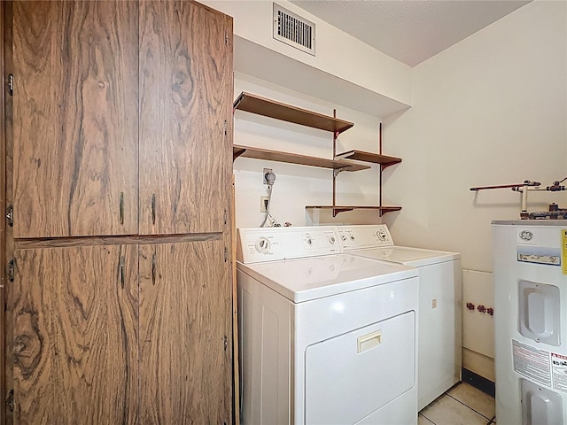 11401 Cypress Dr, Clermont, FL 34711 - washroom featuring water heater, independent washer and dryer, and light tile patterned floors