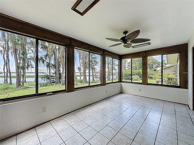 11401 Cypress Dr, Clermont, FL 34711 - unfurnished sunroom with a textured ceiling, a water view, and tile patterned flooring
