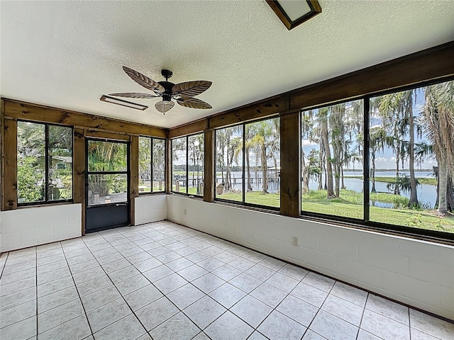 11401 Cypress Dr, Clermont, FL 34711 - unfurnished sunroom featuring a water view, ceiling fan, a textured ceiling, and healthy amount of natural light