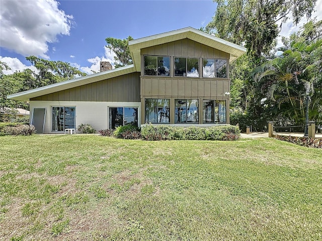11401 Cypress Dr, Clermont, FL 34711 - rear view of property with a chimney and a yard