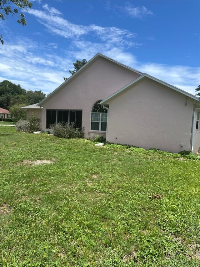 5268 SW 110th Pl, Ocala, FL 34476 - back of property featuring stucco siding and a lawn
