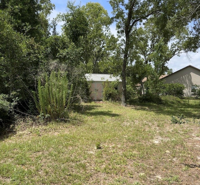 5268 SW 110th Pl, Ocala, FL 34476 - view of green lawn with a storage unit