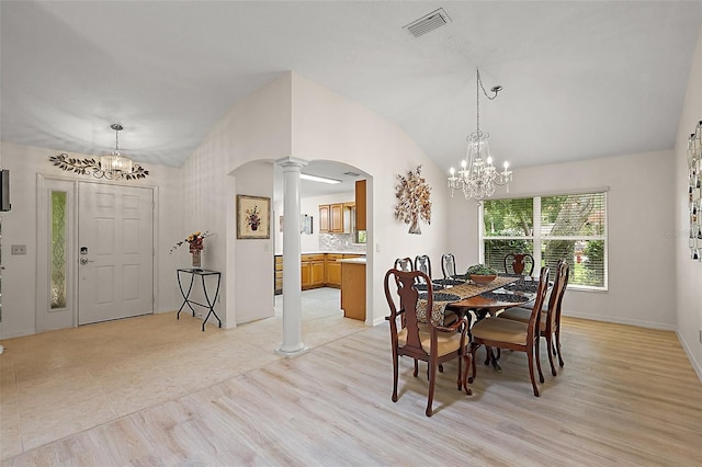 1002 Amarillo Pl, The Villages, FL 32159 - dining room with a chandelier, ornate columns, arched walkways, lofted ceiling, and light wood-style floors