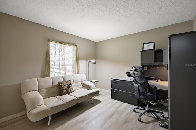 1002 Amarillo Pl, The Villages, FL 32159 - home office with light wood finished floors and a textured ceiling