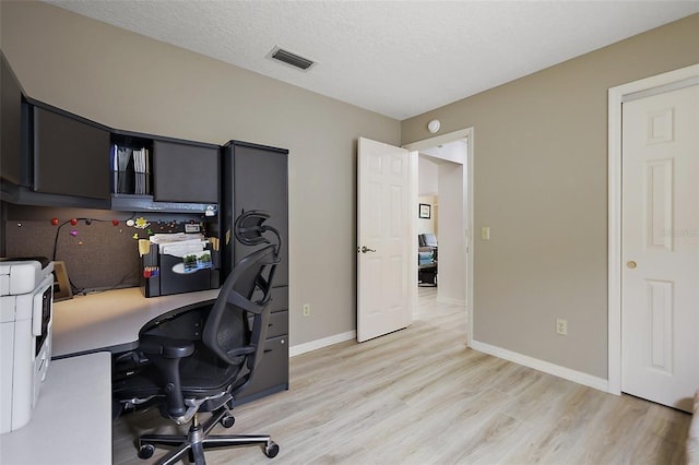 1002 Amarillo Pl, The Villages, FL 32159 - home office with light wood-style flooring and a textured ceiling