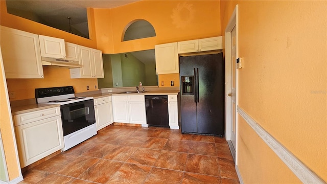 12512 Draw Dr, Grand Island, FL 32735 - kitchen with black appliances, under cabinet range hood, white cabinets, light countertops, and a towering ceiling