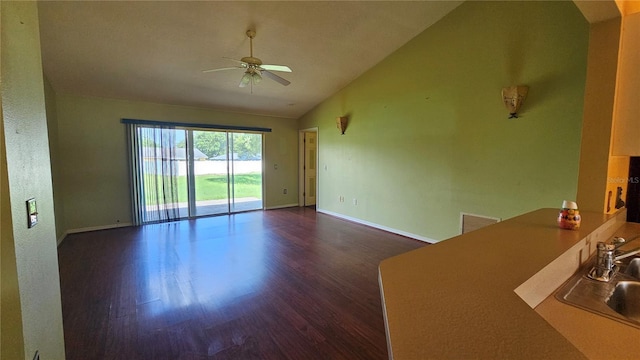 12512 Draw Dr, Grand Island, FL 32735 - unfurnished living room featuring vaulted ceiling, ceiling fan, and dark wood-style floors