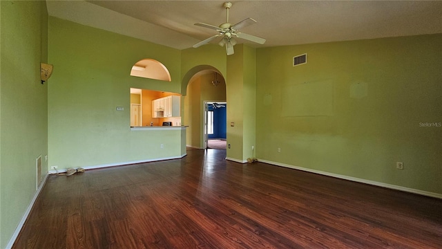 12512 Draw Dr, Grand Island, FL 32735 - unfurnished room with a ceiling fan, dark wood finished floors, arched walkways, and high vaulted ceiling
