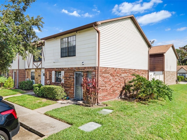 3401 Sunrise Villas Ct S, Tampa, FL 33614 - view of property featuring a front lawn and brick siding