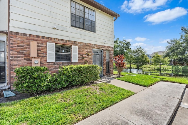 3401 Sunrise Villas Ct S, Tampa, FL 33614 - view of front of house with a front lawn and a water view